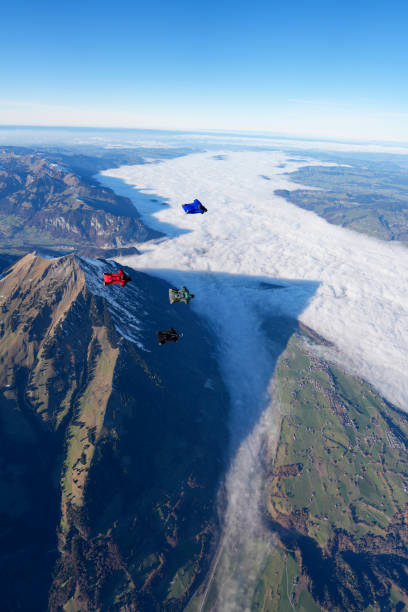 istock Wingsuit fliers soar over mountains and fog 2187806905