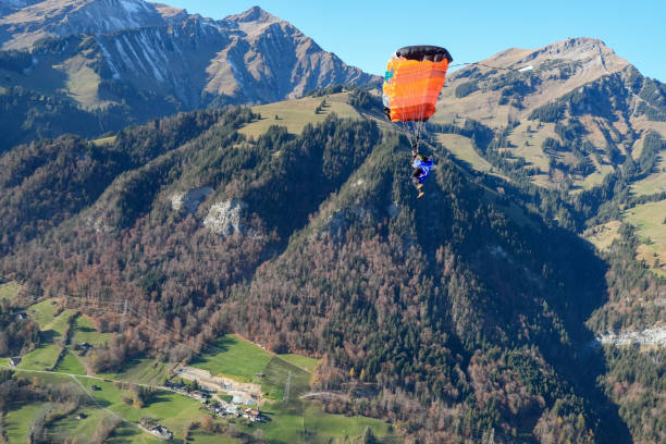 istock Paraglider soars over lush valley, Swiss Alps 2187806908
