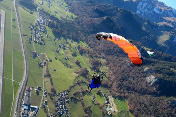 istock Paraglider soars over lush valley, Swiss Alps 2187806909