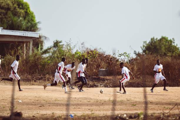 Abidjan, Ivory Coast – November 05, 2024: Young people playing football on an open field