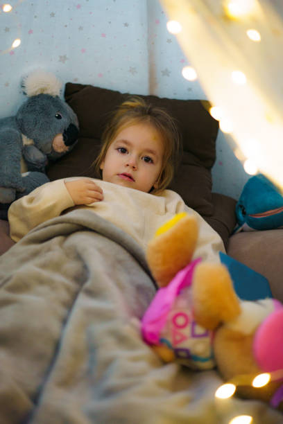 istock Girl lying in tent at home 2187810336