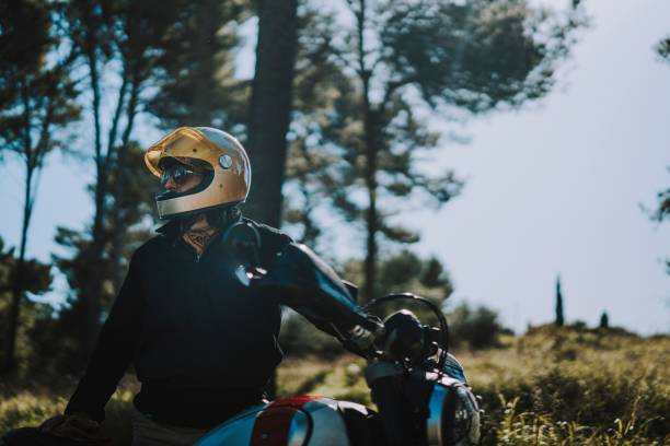 istock Motorcyclist in Sunlit Forest 2187810639