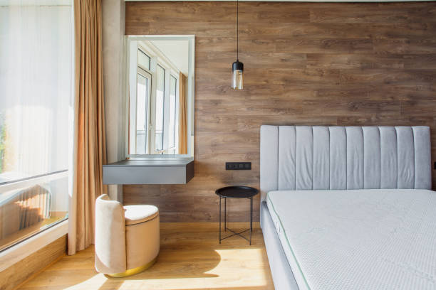 istock large modern bedroom bed with headboard warm wooden laminate on wall 2187816863