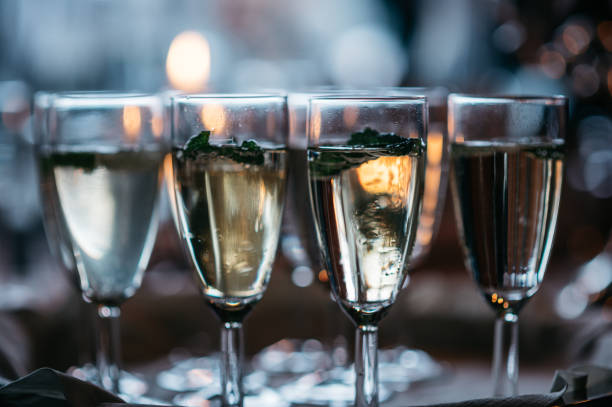 istock Elegant Champagne Flutes with Mint Garnish in Moody Lighting 2187817132