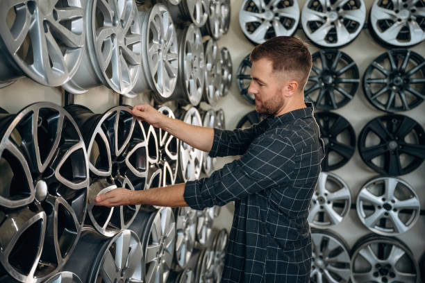 istock Choosing the right disk. Man worker is maintenance station with tires, wheels 2187818033