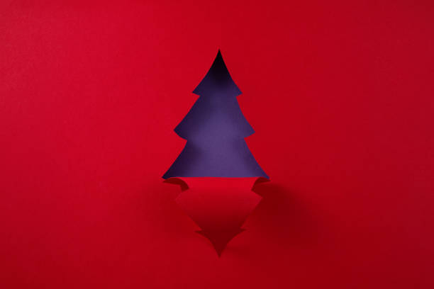 Christmas decorations handmade from red and green felt on a wooden background.