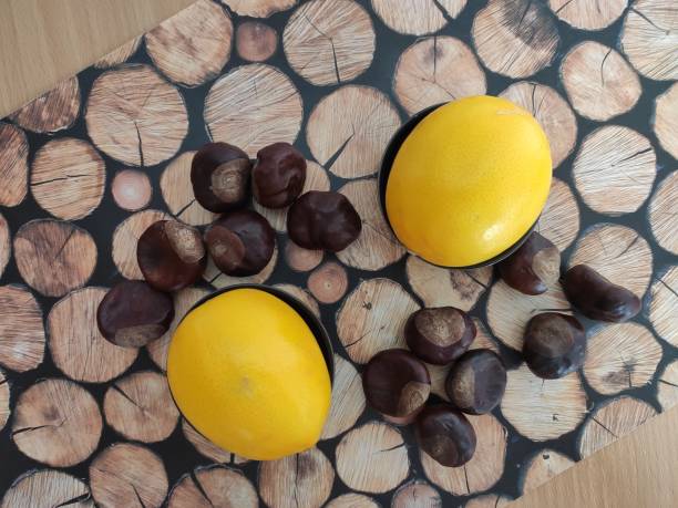 istock Yellow Lemons, almonds and shiny brown chestnuts on the table 2187820978