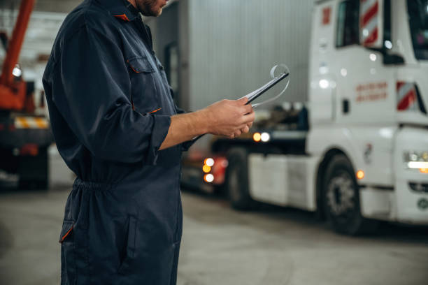 istock Documents in notepad. Male worker is in the modern warehouse or manufacturing company 2187821968