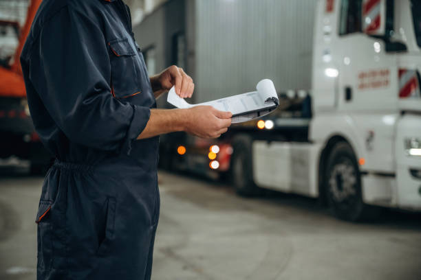 istock Documents in notepad. Male worker is in the modern warehouse or manufacturing company 2187822121