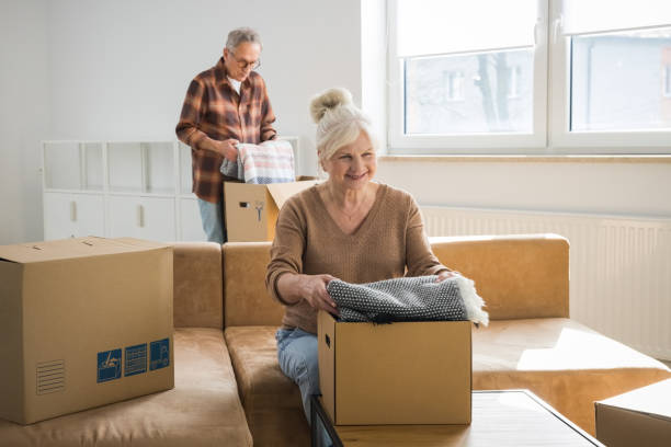 istock Senior couple packing cardboard boxes 2187824341