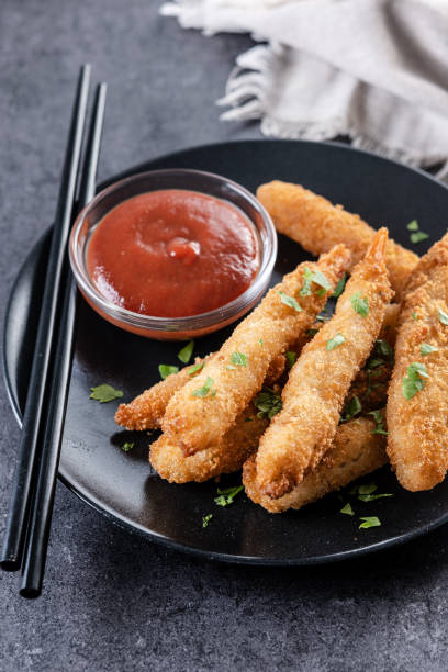 istock Breaded Torpedo shrimps on black slate background 2187826823