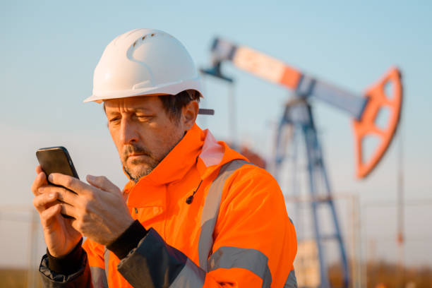 istock Drilling rig engineer using mobile phone while supervising the process of oil and gas, monitoring rig performance in field 2187826869