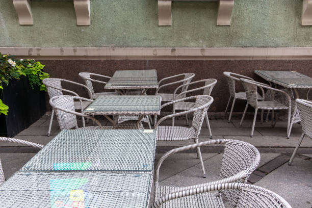 istock A patio with many chairs and tables, some of which are empty 2187827097