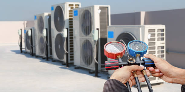 istock Air conditioning, HVAC service technician using gauges to check refrigerant and add refrigerant. 2187828956