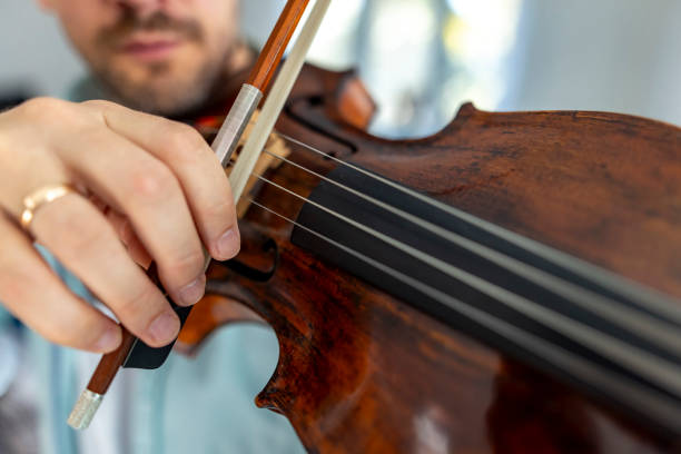 istock Close-Up Of Musician Playing Violin With Focus On Strings And Bow 2187829929