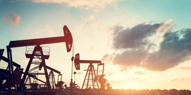 istock Multiple oil pumps extracting resources at sunset. Oil industry 2187831764