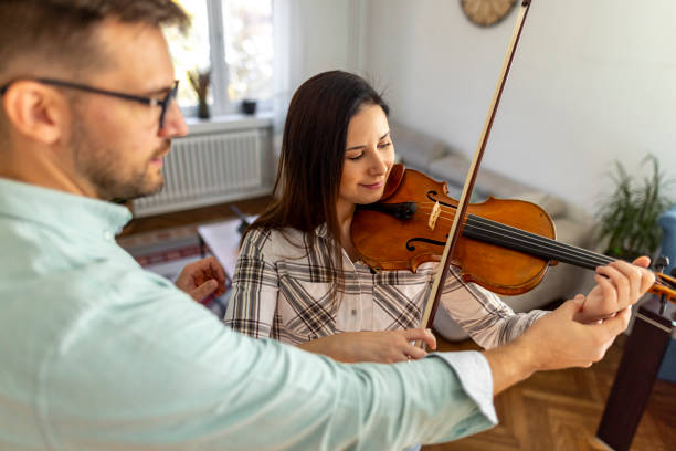 istock Violin Lesson With Teacher Assisting Beginner Student Playing Instrument 2187831915