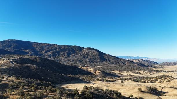 istock Scenic view of hills and mountains under a clear blue sky. 2187832124