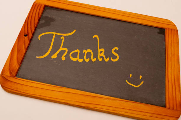 written in gold letters on a chalkboard Thanks