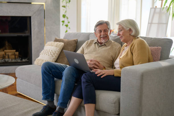 istock Smiling Elderly Couple Sharing a Moment with a Laptop 2187834565