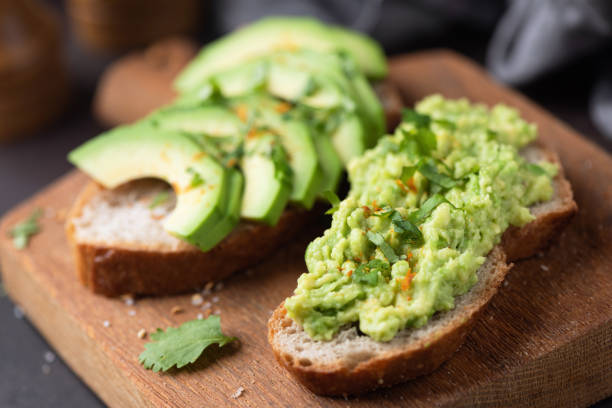 istock Avocado toasts on a wooden cutting board 2187834662