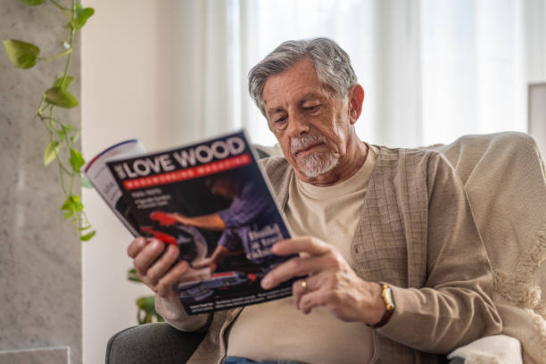 istock Senior Man Immersed in Reading a Magazine 2187834800