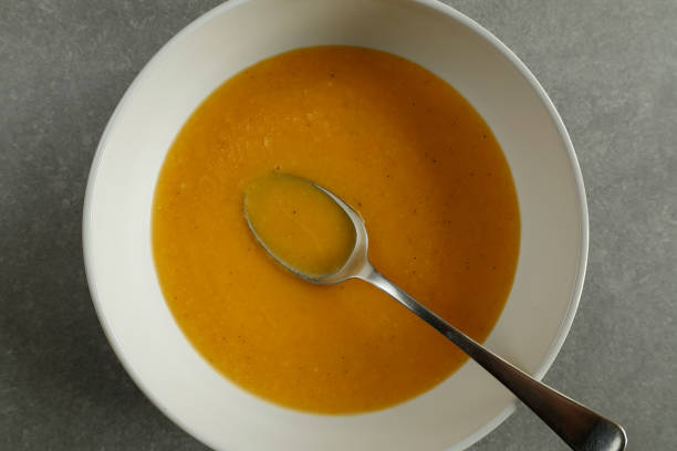 istock bowl of creamy vegetable soup with spoon 2187839049