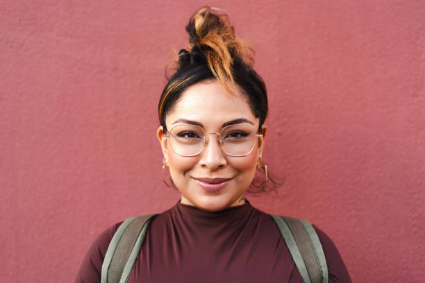 istock Confident young latin student poses against a vibrant red background, exuding modernity and urban style while embracing empowerment and diversity 2187842817