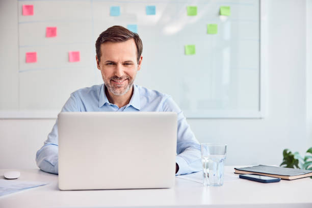 istock Businessman working at office desk using laptop 2187843555