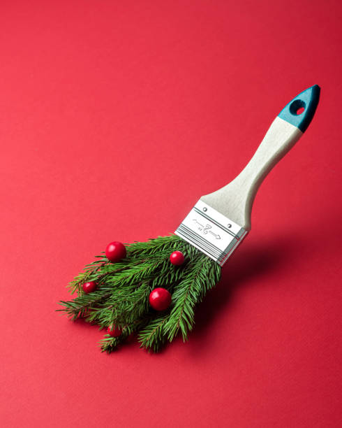 istock An original composition featuring a paintbrush with pine branches and red berries replacing bristles, on a red background. Creative minimalist Christmas concept. 2187846317