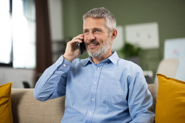 istock Businessman having a business call while taking a break on the sofa 2187846438