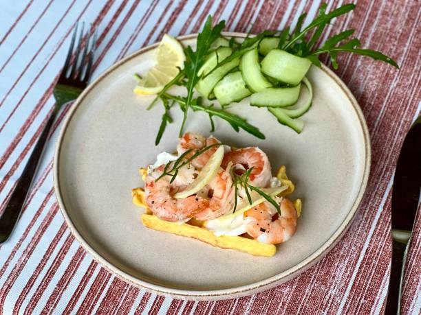 istock Sandwich with shrimp, lemon, cucumber, and arugula served on a light plate 2187850006