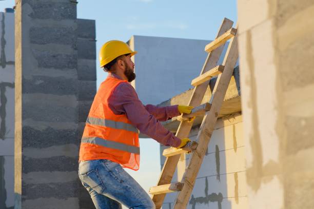 istock Construction worker inspecting building on ladder at sunset 2187850768
