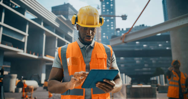 istock Portrait of a Handsome Black Civil Engineer Working on a Tablet at a Construction Site. Young African Man Standing Outdoors, Using Computer Device for Planning and Developing a Real Estate Project 2187852221