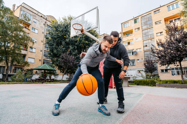 istock Two Young Men Playing Basketball 2187854288