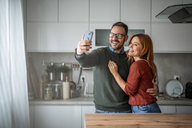 istock Charming couple making memories with a selfie in the kitchen 2187855459