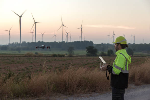 istock Survey Team Alternative energy for future. Engineers survey and checking wind turbines in sunset. Wind Turbine Renewable energy technology and sustainability. 2187856806