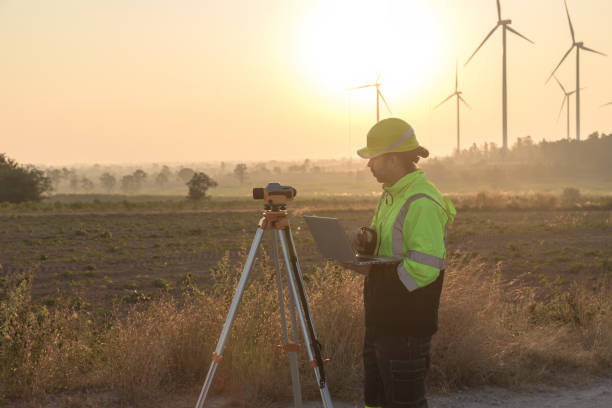 istock Survey Team Alternative energy for future. Engineers survey and checking wind turbines in sunset. Wind Turbine Renewable energy technology and sustainability. 2187856812