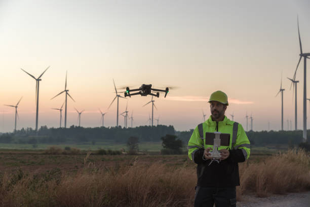 istock Survey Team Alternative energy for future. Engineers survey and checking wind turbines in sunset. Wind Turbine Renewable energy technology and sustainability. 2187856816