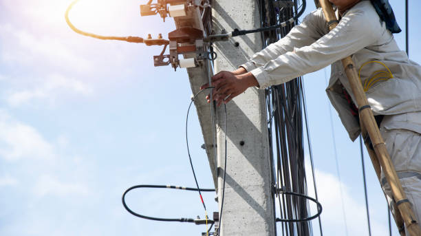 istock The technician is repairing the cables on the electric pole. 2187857200