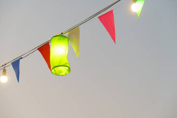 Colorful lanterns and flags create festive atmosphere outdoors.