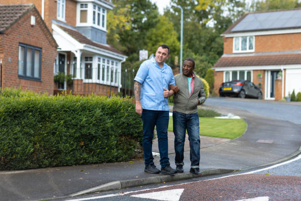 istock Nurse and Patient Preparing to Cross a Road 2187858285