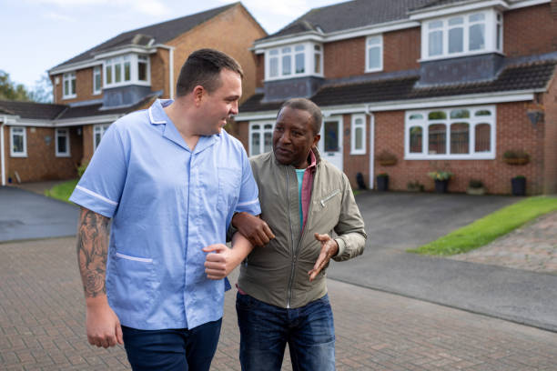 istock Nurse and Patient Enjoying a Walk Around the Block 2187858324