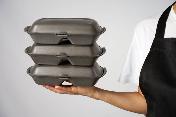 istock Waitress woman hand with a lunch box, close-up 2187859734