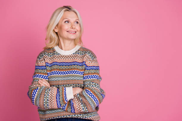 istock Photo of nice aged lady folded arms look empty space wear pullover isolated on pink color background 2187860980