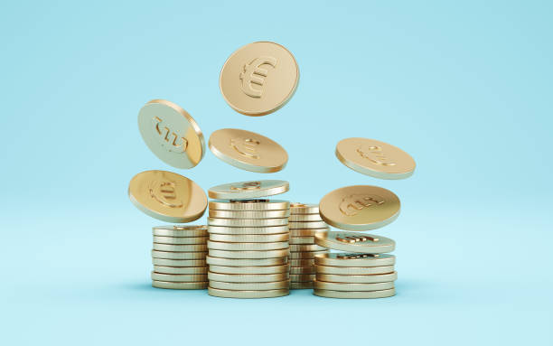istock Euro Gold Coins on Blue Soft Infinite Background 2187863327