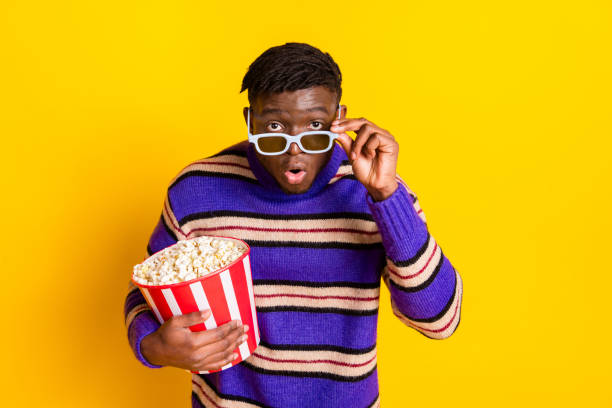 istock Photo of nice young man 3d glasses pop corn wear pullover isolated on yellow color background 2187864963