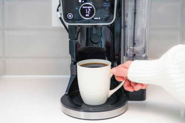 istock hand holding a cup of coffee 2187865049
