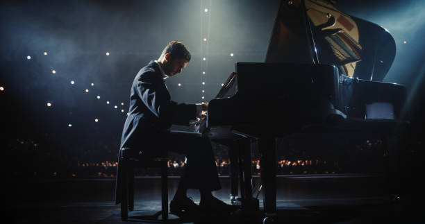 istock Young Pianist Playing Academic Music, Performing Classical Solo Compositions on Stage. Grand Piano Resounds With Rich, Melodic Tones of a Romantic Ballad, Pianist Filling Each Chord with Nostalgia 2187865083