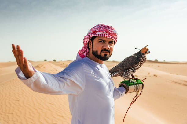 istock arab man with falcon in the desert 2187865293